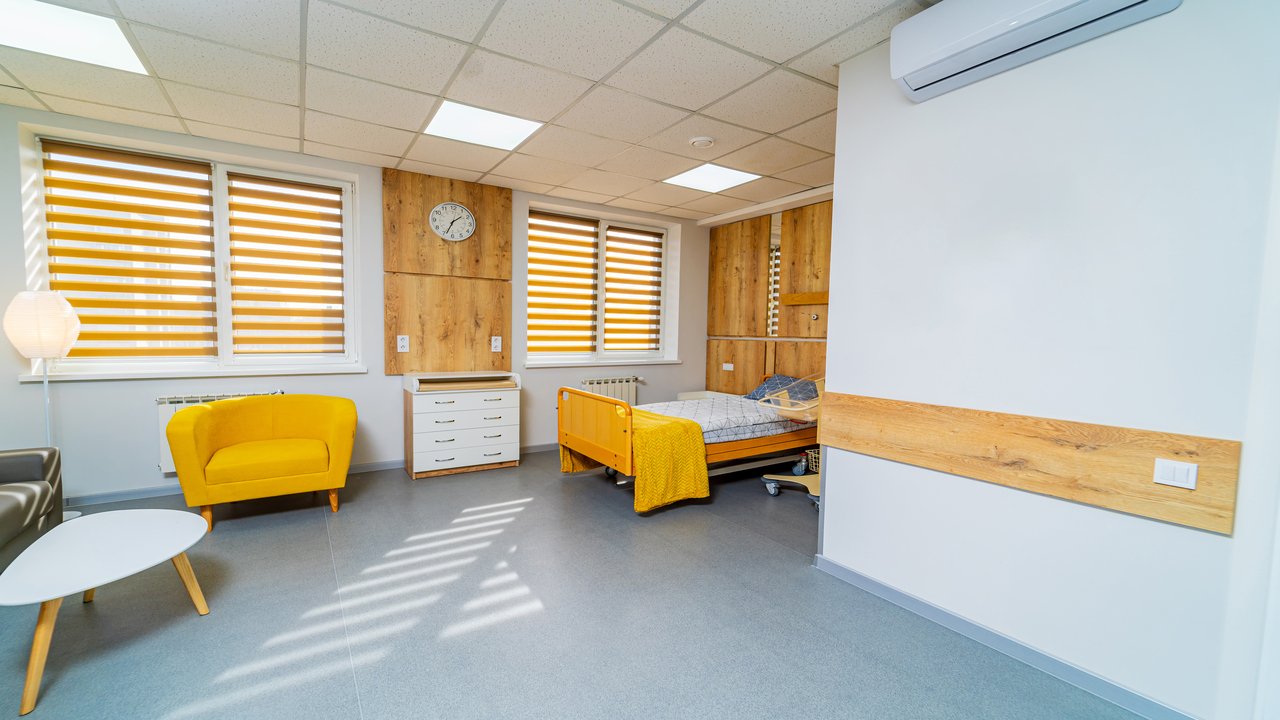Empty comfortable healthcare recovery room. Interior of modern hospital ward.